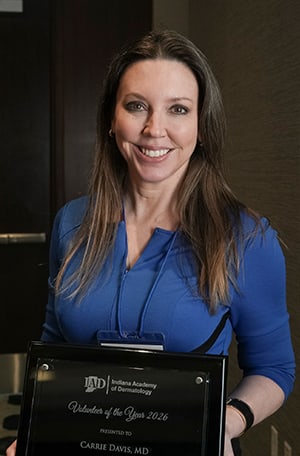 Smiling woman holding an award